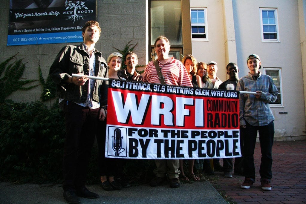 WRFI staff and volunteers outside WRFI headquarters in the back of the Historic Clinton House in downtown Ithaca. Photo credit: Liz