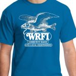 Image of a torso wearing a blue t-shirt with a flying fish wearing headphones and black text that reads "WRFI Community Radio Live local independent"
