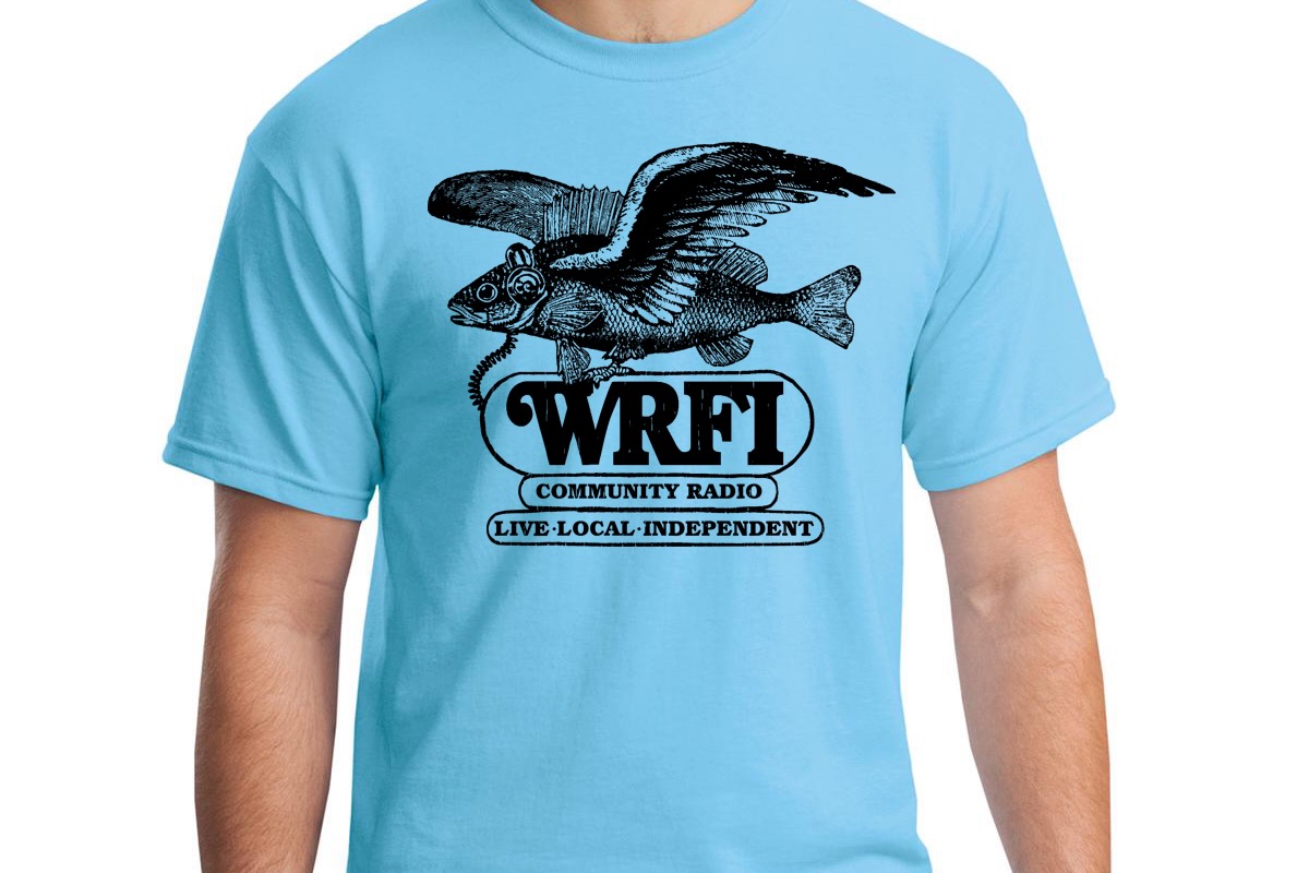 Image of a torso wearing a light blue t-shirt with a flying fish wearing headphones and black text that reads "WRFI Community Radio Live local independent"