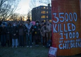 Students rally as the sun sets on the encampment's first day. (Photo: Caleb K for the Ithacan)